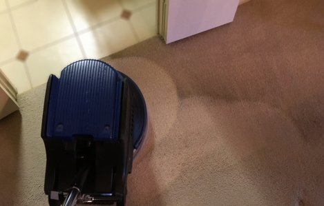 Scrubbing living room carpet to be clean by Sanitize 4 Serenity